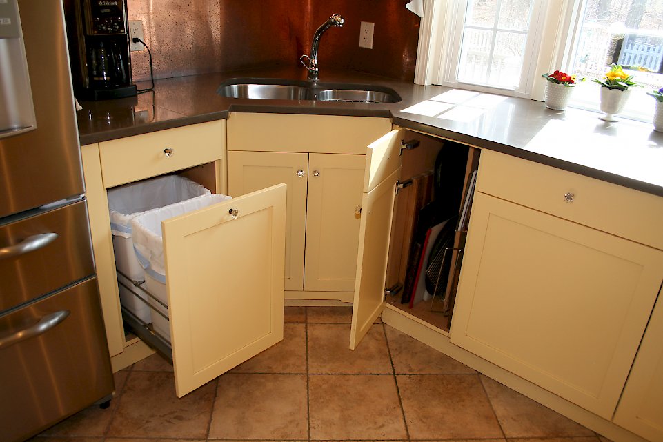 The double bin trash pull-out and cabinet for storing large pans.