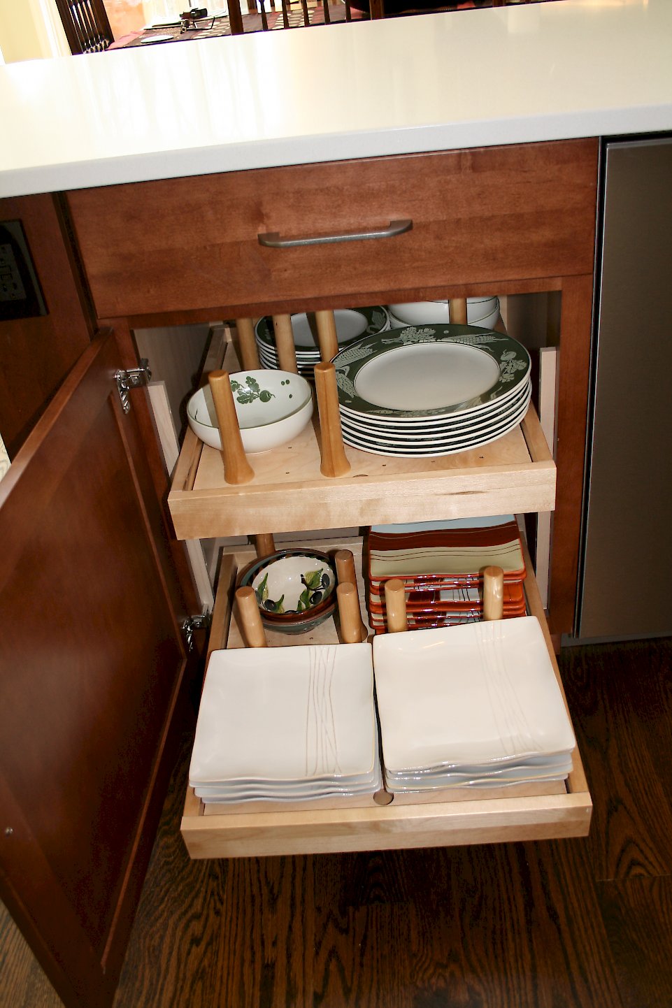 Pull out drawers with pegs to hold dishes.