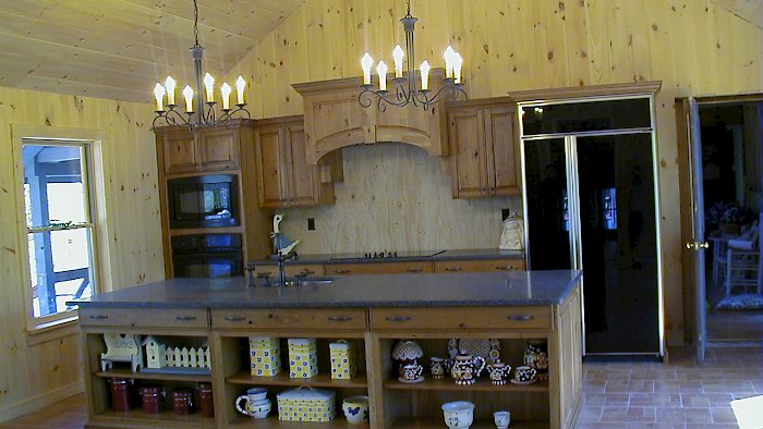 A rustic knotty cherry kitchen with honed ash black granite counter-tops.