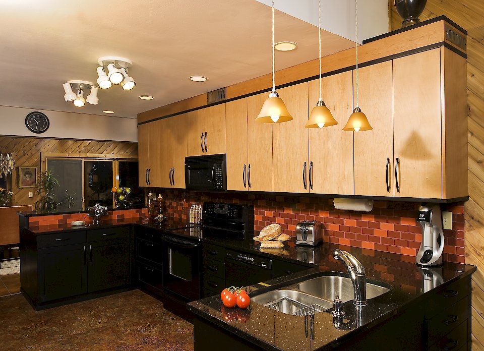 Two toned Brookhaven kitchen with galaxy black granite counters.