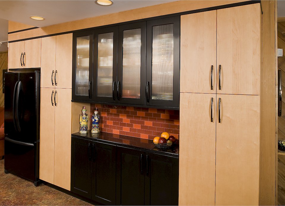 Tall pantry cabinets on the opposite side of the kitchen.