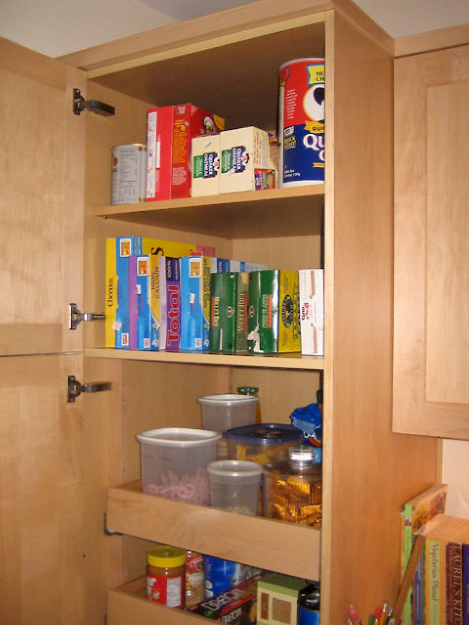 Tall pantry cabinet pull-out drawers on the bottom and regular shelving on top.