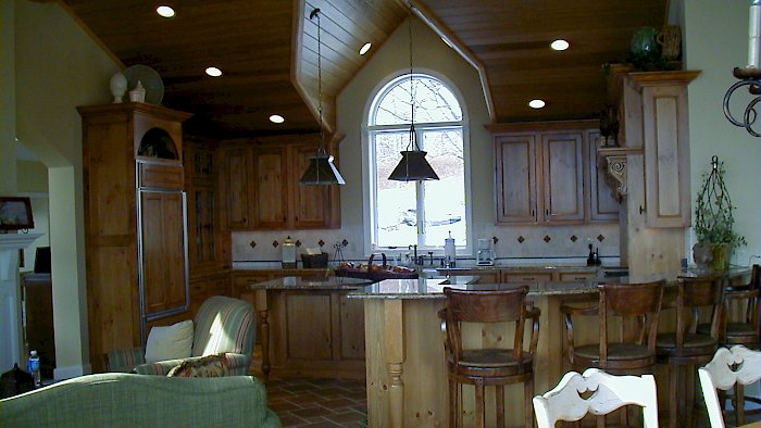 A Distressed Pine Wood-Mode kitchen with an Essex Door style.