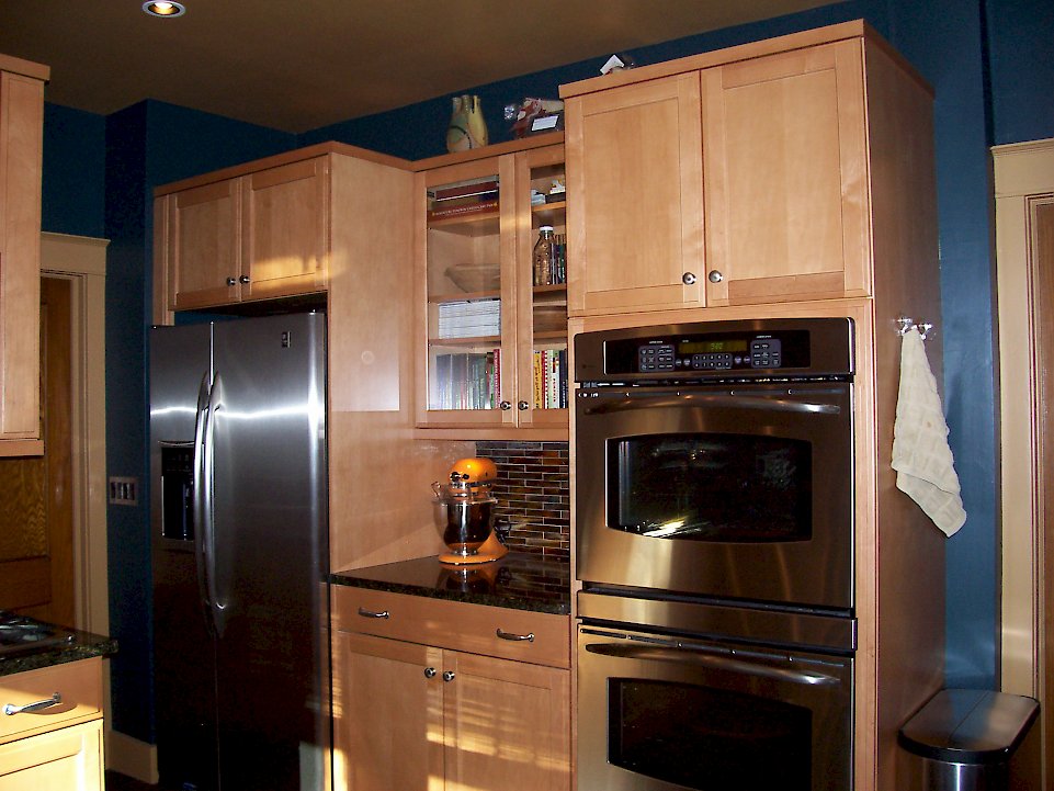 A stainless steel double oven and refrigerator.