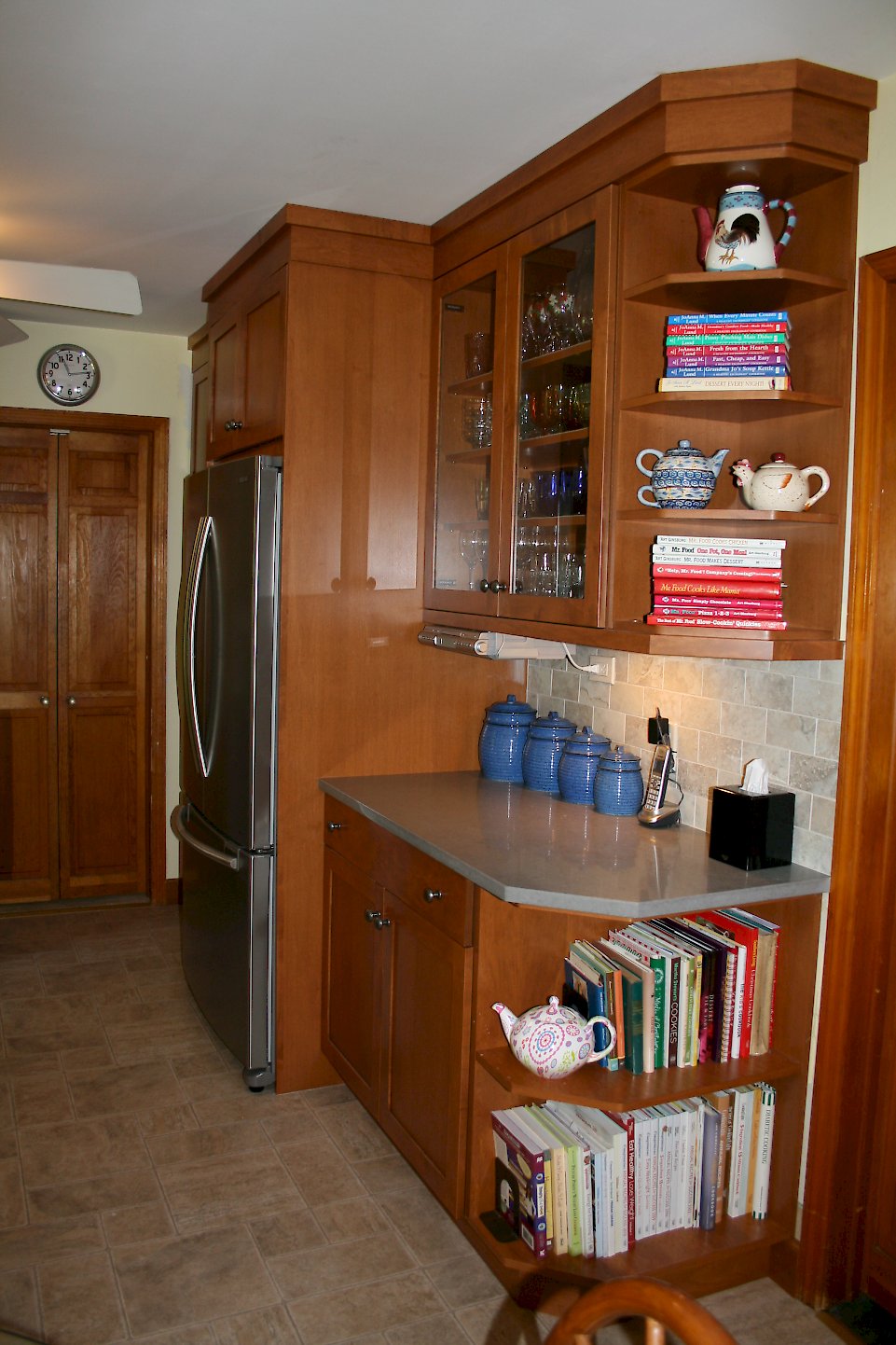 Open shelving at the end of the cabinetry.