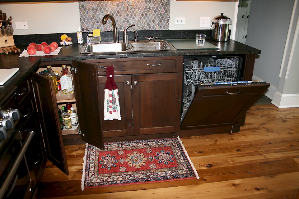 Hidden dishwasher with a wooden panel.