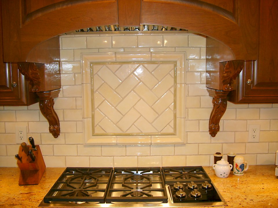 Custom tile backspash and Wolf gas cooktop.