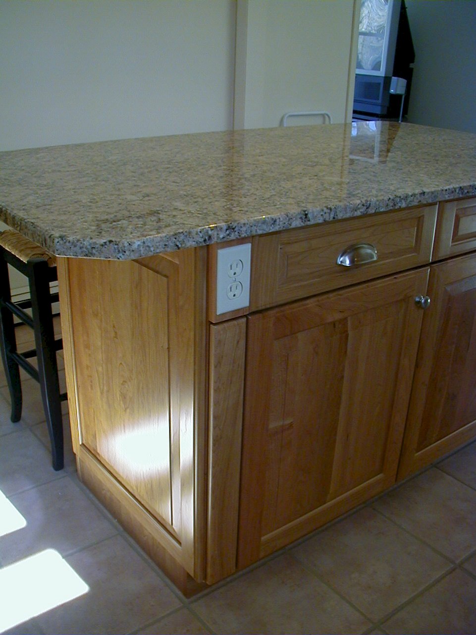 An outlet integrated into the kitchen island.