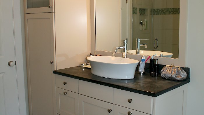 Brookhaven Vanity and tall cabinet with a vessel sink.