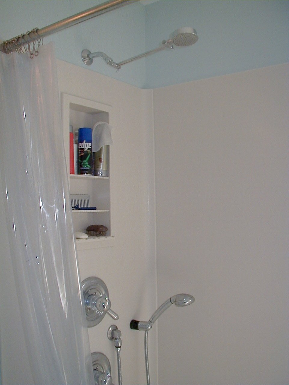 Corian surround on the shower walls.